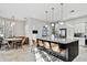 Modern kitchen features a large center island with seating and stainless steel appliances at 3844 Wellington Pkwy, Palm Harbor, FL 34685