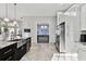 Spacious kitchen with stainless steel appliances, granite countertops, and a view to the billiards room at 3844 Wellington Pkwy, Palm Harbor, FL 34685