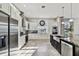Modern kitchen with stainless steel appliances, stone countertops, custom cabinets, and tile flooring at 3844 Wellington Pkwy, Palm Harbor, FL 34685
