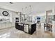 Open kitchen with stainless steel appliances, stone countertops, custom cabinets, and tile flooring at 3844 Wellington Pkwy, Palm Harbor, FL 34685
