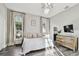 Spacious main bedroom with hardwood style floors, neutral paint, and large arched windows at 3844 Wellington Pkwy, Palm Harbor, FL 34685