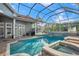 Beautiful pool featuring a spa and screened enclosure at 3844 Wellington Pkwy, Palm Harbor, FL 34685