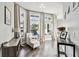 This sitting room features a neutral color palette, hardwood style floors, and large windows at 3844 Wellington Pkwy, Palm Harbor, FL 34685