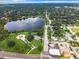 Breathtaking aerial view of a neighborhood with mature trees surrounding a peaceful lake at 405 S Lake Dr, Clearwater, FL 33755