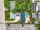Aerial view of the property showcasing a pool, parking, and surrounding greenery at 405 S Lake Dr, Clearwater, FL 33755
