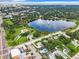 An aerial view of a lake with fountain, park, and community amenities at 405 S Lake Dr, Clearwater, FL 33755