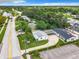An aerial view showing lake and several homes with pools and surrounding neighborhood at 405 S Lake Dr, Clearwater, FL 33755