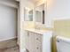 Bright bathroom featuring a modern vanity, stylish mirror, and wood-look flooring at 405 S Lake Dr, Clearwater, FL 33755