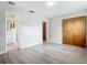 Neutral bedroom with wood-look floors, a spacious closet, and an attached bathroom at 405 S Lake Dr, Clearwater, FL 33755