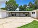 Spacious carport area with concrete flooring, providing ample parking and outdoor space at 405 S Lake Dr, Clearwater, FL 33755