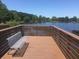 Lakeside dock area featuring wood decking, a metal bench, and scenic views at 405 S Lake Dr, Clearwater, FL 33755