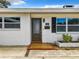Inviting front entrance featuring a stylish front door, tiled steps, and brick facade at 405 S Lake Dr, Clearwater, FL 33755