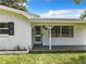 Charming home with a covered front porch and well-maintained lawn at 405 S Lake Dr, Clearwater, FL 33755