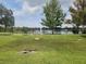 Scenic lake view showcasing a lush grassy area and a tranquil waterfront at 405 S Lake Dr, Clearwater, FL 33755