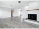 Bright living room featuring a fireplace, and seamless access to other living spaces at 405 S Lake Dr, Clearwater, FL 33755