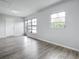 Cozy living room featuring modern floors, white walls, large windows, and a glass door at 405 S Lake Dr, Clearwater, FL 33755
