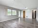 Bright living room with large window and wood-look flooring at 405 S Lake Dr, Clearwater, FL 33755