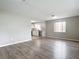 Open-concept living area showcases wood-look floors and connects seamlessly to a bright white kitchen at 405 S Lake Dr, Clearwater, FL 33755