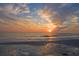 Picturesque ocean view featuring a tranquil beach with calming waves and a soft, colorful sunset at 405 S Lake Dr, Clearwater, FL 33755