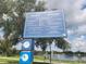 Informative park sign at Crest Lake Park with park rules and regulations in English and Spanish at 405 S Lake Dr, Clearwater, FL 33755