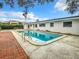 Backyard pool surrounded by a spacious patio, offering a refreshing oasis with ample space for recreation at 405 S Lake Dr, Clearwater, FL 33755