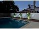Night view of a private pool with fence and landscape lighting at 405 S Lake Dr, Clearwater, FL 33755