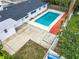 Aerial view of the fenced backyard featuring a private pool, patio area, and well-maintained landscaping at 405 S Lake Dr, Clearwater, FL 33755