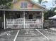 Unique storefront 'Oddities' with quirky decorations and prominent parking space art at 405 S Lake Dr, Clearwater, FL 33755