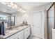 Bathroom featuring granite countertops with dual sinks and a tiled walk-in shower at 4195 Welling Ter, Land O Lakes, FL 34638
