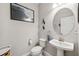 Cozy bathroom featuring a pedestal sink, decorative mirror, and themed artwork at 4195 Welling Ter, Land O Lakes, FL 34638
