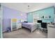 Bedroom with colorful walls, white furnishings, and ample natural light at 4195 Welling Ter, Land O Lakes, FL 34638