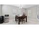 A dining room area with a dark wood table, seating for four, and natural light from three windows at 4195 Welling Ter, Land O Lakes, FL 34638