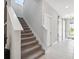 Bright entryway features tiled floors, stairs, and a modern sliding barn door at 4195 Welling Ter, Land O Lakes, FL 34638