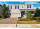 Charming two-story home featuring a well-manicured lawn and brick paved driveway at 4195 Welling Ter, Land O Lakes, FL 34638