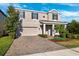 Charming two-story home featuring a well-manicured lawn and brick paved driveway at 4195 Welling Ter, Land O Lakes, FL 34638