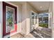 Inviting front porch with decorative front door and views of the screened-in pool at 4195 Welling Ter, Land O Lakes, FL 34638