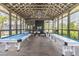 Community game room with pool tables, ping pong tables, and ample natural light at 4195 Welling Ter, Land O Lakes, FL 34638