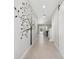Spacious hallway with tree mural, tiled floor, and natural light at 4195 Welling Ter, Land O Lakes, FL 34638