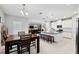 A kitchen open to dining and living spaces, featuring a center island with barstool seating at 4195 Welling Ter, Land O Lakes, FL 34638
