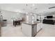 Open-concept kitchen with an island, stainless steel appliances, and adjacent living area at 4195 Welling Ter, Land O Lakes, FL 34638