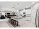 Bright kitchen features white cabinets, stainless appliances, and large island with seating at 4195 Welling Ter, Land O Lakes, FL 34638