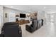 A cozy living room featuring reclining leather seating, a large screen TV, and movie-themed decor at 4195 Welling Ter, Land O Lakes, FL 34638