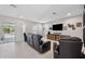 A living room features a large screen TV, media console, and a sliding glass door at 4195 Welling Ter, Land O Lakes, FL 34638