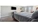 Carpeted primary bedroom with a bed, furniture, and a wall-mounted TV at 4195 Welling Ter, Land O Lakes, FL 34638
