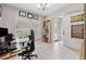 A bright office with a large desk, ergonomic chair, and natural light from two windows at 4195 Welling Ter, Land O Lakes, FL 34638