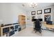 Well-lit home office with built-in shelving, desk, and neutral wall color at 4195 Welling Ter, Land O Lakes, FL 34638