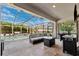 Covered patio with outdoor kitchen and dining space with a clear view of the sparkling pool at 4195 Welling Ter, Land O Lakes, FL 34638
