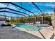 Wide shot of the screened in pool with comfortable seating and a sunny sky overhead at 4195 Welling Ter, Land O Lakes, FL 34638