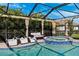 Inviting screened-in pool and spa area with lounge chairs and comfortable outdoor seating under a sunny sky at 4195 Welling Ter, Land O Lakes, FL 34638