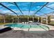 Screened-in pool with a beach entry and a spa, along with plenty of room to sit and relax at 4195 Welling Ter, Land O Lakes, FL 34638